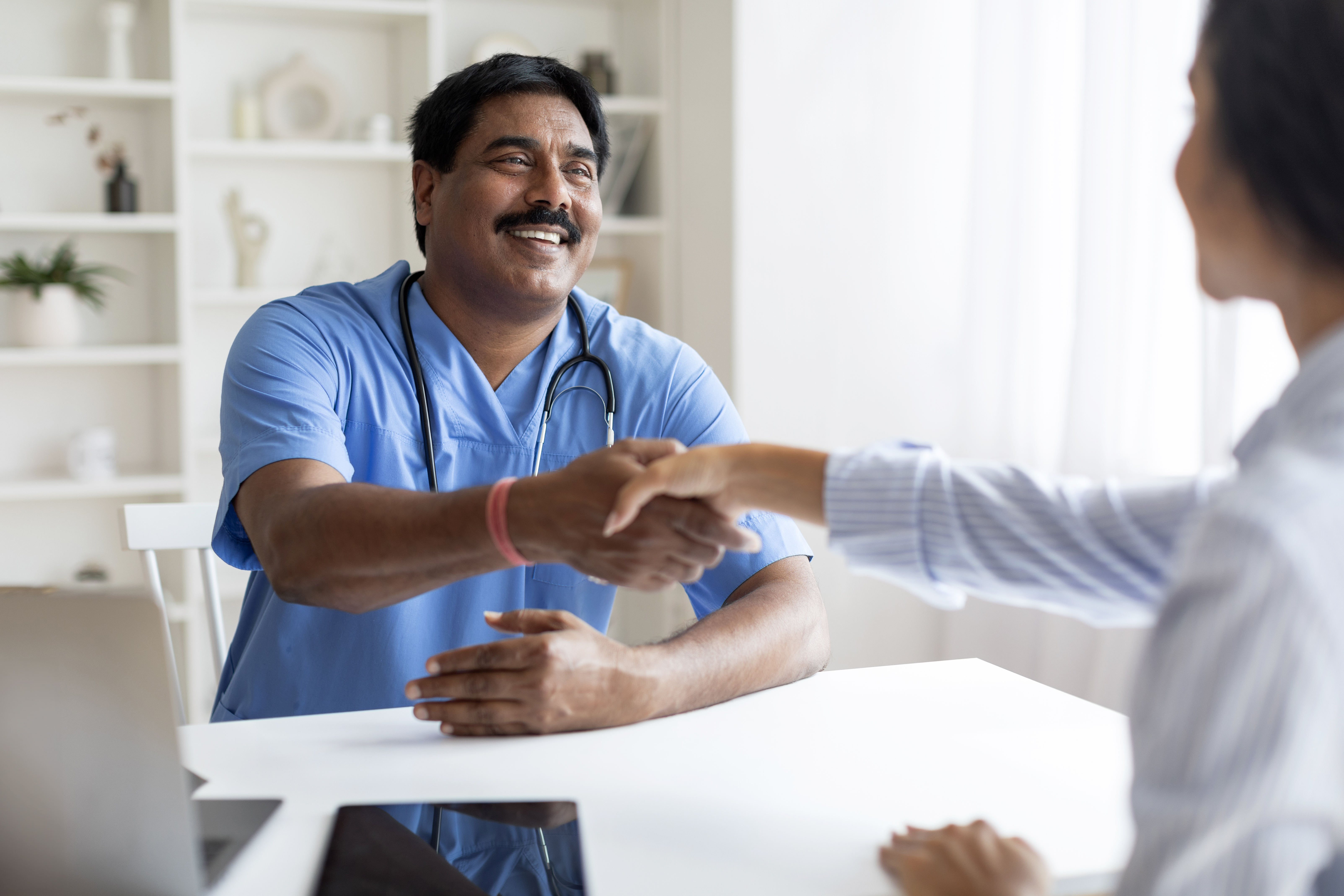 Smiling doctor greeting patient